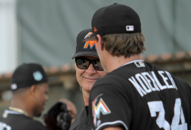 Miami Marlins pitchers and catchers began spring training Tuesday at Roger Dean Stadium in Jupiter. Manager Don Mattingly, left, and pitcher Tom Koehler (34), right, talk during training. Randy Vazquez, South Florida Sun-Sentinel