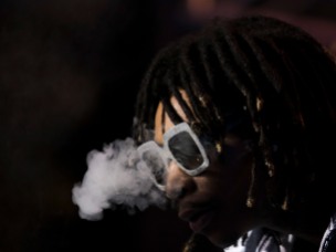 Wiz Khalifa blows smoke during his performance at Okeechobee Music and Art Festival Friday night. Randy Vazquez, SouthFlorida.com