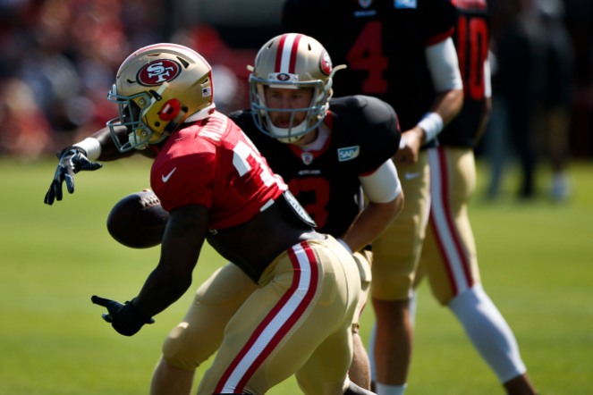 San Francisco 49ers' running back Joe Williams (32), left, receives a handoff from quarterback C.J. Beathard (3), right, during training camp at the teams' practice facility in Santa Clara, Calif., on Tuesday, July 31, 2018. (Randy Vazquez/ Bay Area News Group)