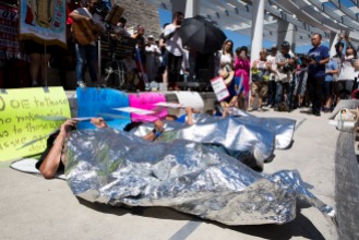 Members of Grupo la Solidaridad lay blanketed on the ground to represent the many children at U.S. Customs and Border Protection detention centers who sleep under mylar blankets during a "Families Belong Together" rally in San Jose, Calif., on Saturday, June 30, 2018. Several rallies were held across the country to protest family separation at the U.S.-Mexico border under President Trump's "zero tolerance" policy. (Randy Vazquez/ Bay Area News Group)