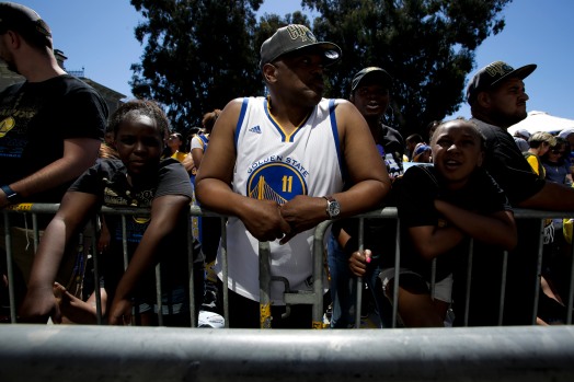 Sa'Tavia Qualls, left, Kelvin Alexander, center, and Amariyana Blair, right, wait near Laker Merritt for the Golden State Warriors' championship parade in Oakland, Calif., on Tuesday, June 12, 2018. The Warriors recently swept the Cleveland Cavaliers in the NBA Finals to win their third championship in four years. (Randy Vazquez/ Bay Area News Group)