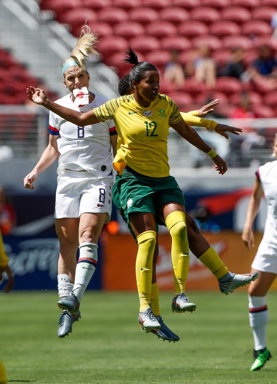 United States midfielder Julie Ertz (8), left, jumps for a header with South Africa's Jermaine Seoposenwe (12), right, during the first half of their friendly game at Levi's Stadium in Santa Clara, Calf., on Sunday, May 12, 2019. Ertz appeared to have suffered an injury in her mouth area. (Randy Vazquez/Bay Area News Group)