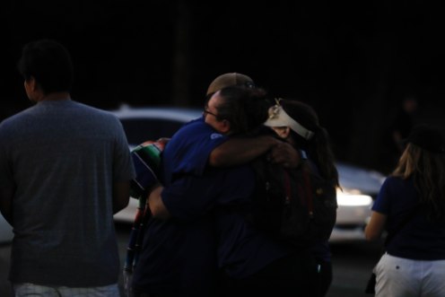 People hug each other at a reunification center at Gavilan College in Gilroy, Calif., on Sunday, July 28, 2019. People were directed to the center following a shooting at the Gilroy Garlic Festival. (Randy Vazquez/Bay Area News Group)