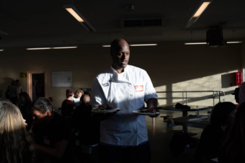 Phillip Sims, a student in the Quentin Cooks program, serves food to guest during graduation dinner at San Quentin State Prison in San Quentin, Calif., on Wednesday, May 22, 2019. The all-volunteer program, brings chefs and inmates together to teach inmates how to work in a commercial kitchen. (Randy Vazquez/Bay Area News Group)