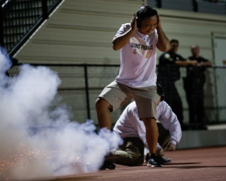 A student sets off a mini canon after Saint Francis scores a touchdown during the third quarter of their game versus Corona del Mar at Saint Francis High School in Mountain View, Calif., on Friday, Aug. 30, 2019. (Randy Vazquez/Bay Area News Group)