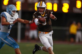 Saint Francis quarterback Ryan Daly (9), right, tries to pick up a first down while being chased by Corona del Mar's Chase Zanck (13), left, during the second quarter of their game at Saint Francis High School in Mountain View, Calif., on Friday, Aug. 30, 2019. (Randy Vazquez/Bay Area News Group)