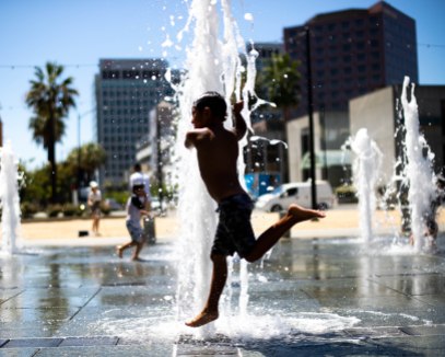 Noah Martinez, 6, jumps through water at the fountains at Cesar Chavez Park in San Jose, Calif., on Wednesday, Aug. 14, 2019. (Randy Vazquez/Bay Area News Group)
